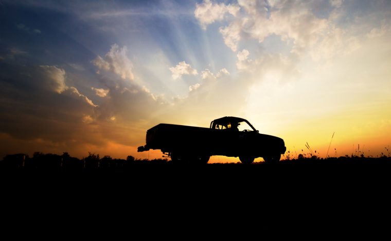 Silhouette of pickup truck on the background of beautiful sunset